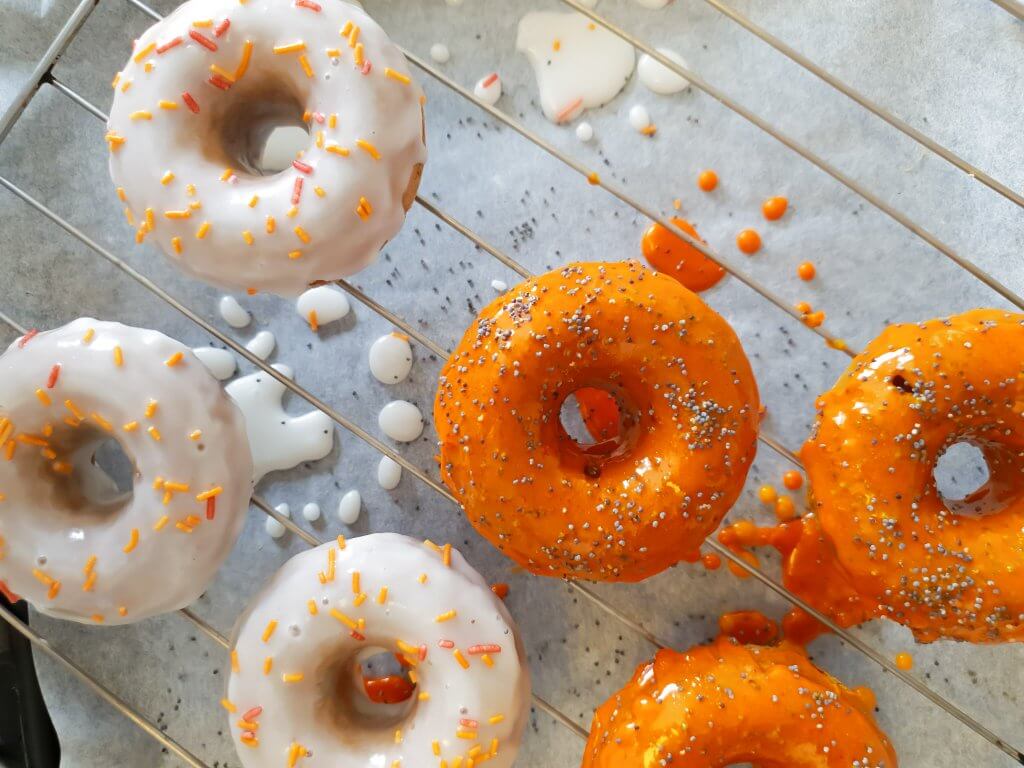  Baked Halloween Pumpkin Donuts - glazing the donuts