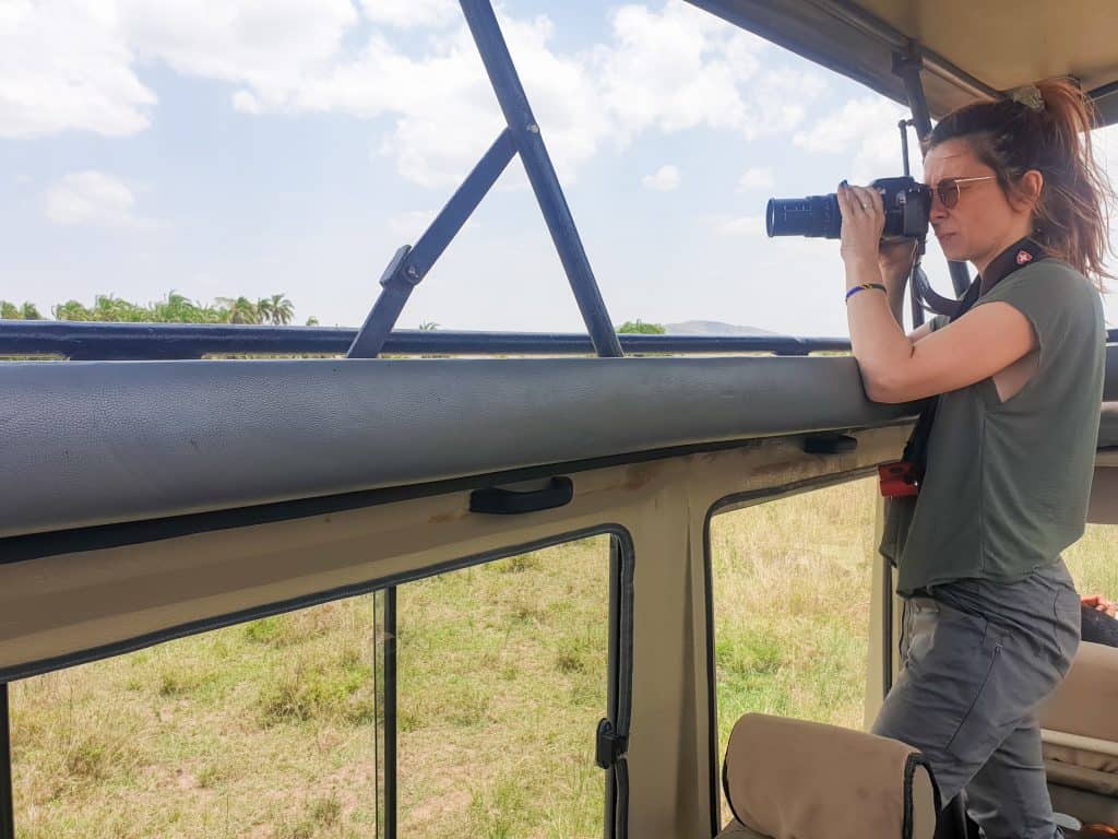 How to plan a safari trip to Africa - taking photo from the safari jeep